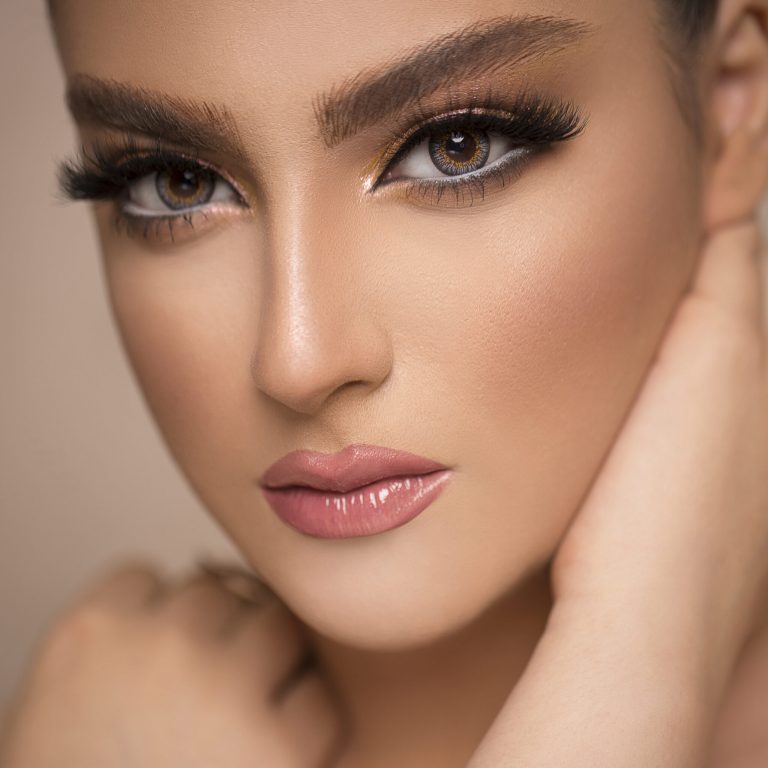 Woman in elegant suntanned makeup promoting skin care